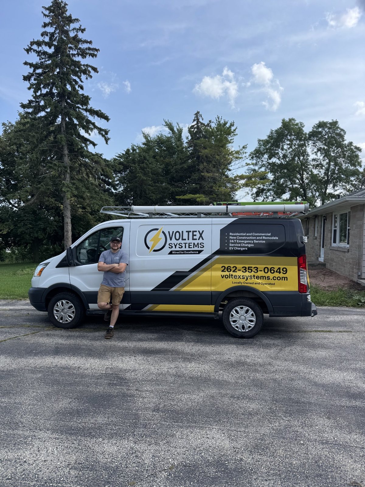 Isaac Weiland, owner of Voltex Systems, with the company work van